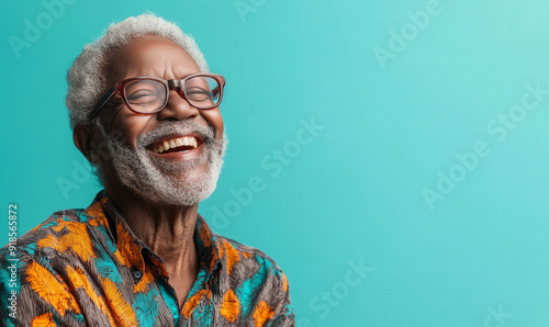 Smiling black senior man, isolated teal blue color background, image with space for text