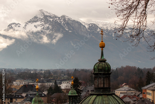 St. Erhard Church in Salzburg against the backdrop of mountains in the snow photo