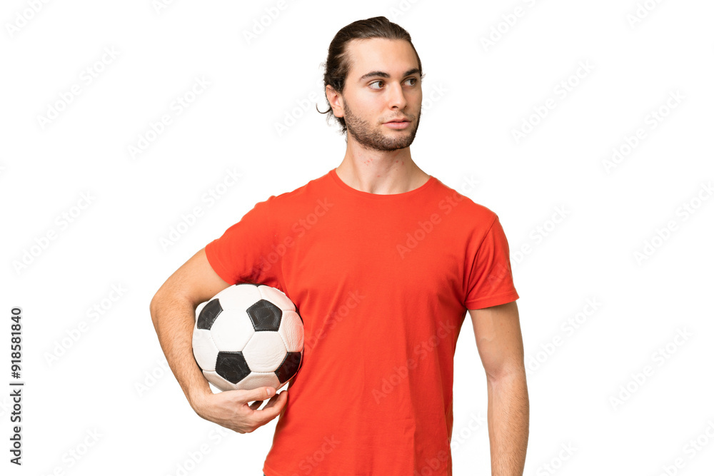 Young handsome man isolated on green chroma background with soccer ball Young handsome man isolated on green chroma background with soccer ball