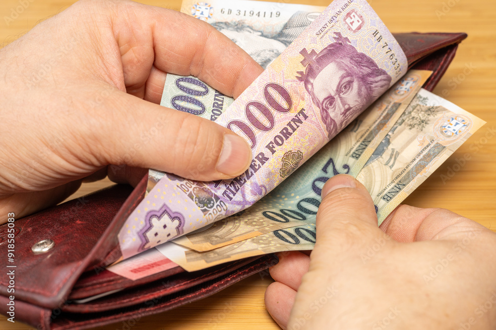 Hungary money. Hand taking money out of wallet. Hungarian forints, financial concept