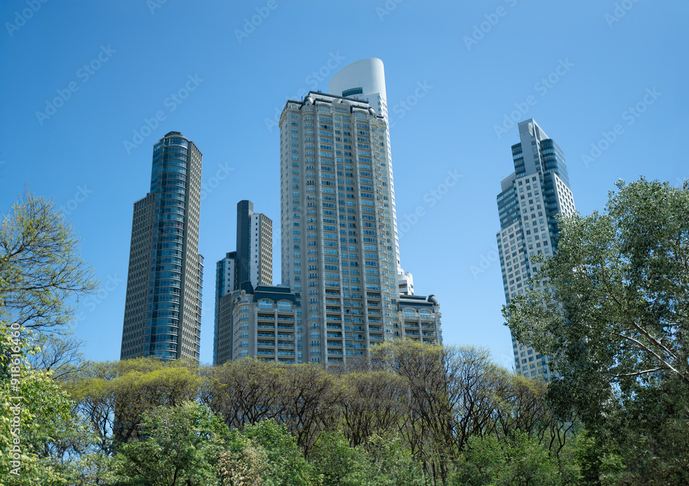 Fototapeta premium large building is in the background of a park with trees