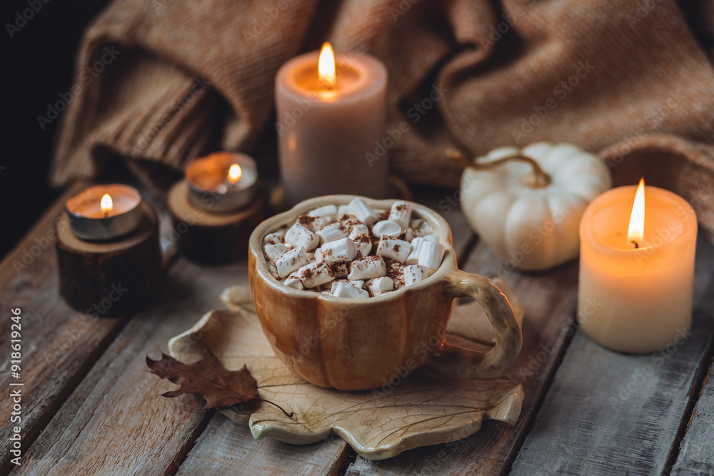 Spicy sweet fall hot drink: delicious pumpkin latte with cinnamon, marshmallow with salted caramel. Served in handmade artisan mug in shape of pumpkins, cozy home decor with candles, dry autumn leaves Spicy sweet fall hot drink: delicious pumpkin latte with cinnamon, marshmallow with salted caramel. Served in handmade artisan mug in shape of pumpkins, cozy home decor with candles, dry autumn leaves