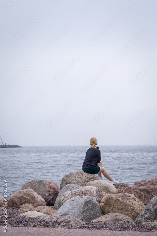 portrait of blonde woman on the beach in Eira Helsinki Finland enjoying the calmness of the sea portrait of blonde woman on the beach in Eira Helsinki Finland enjoying the calmness of the sea