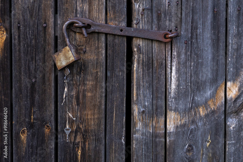 Wallpaper Mural old wooden door locked with rusty padlock. vintage gate to building locked with bolt Torontodigital.ca