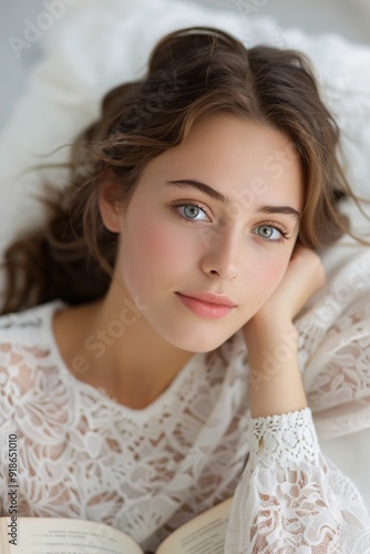 Young Woman in White Lace Blouse Relaxing Indoors and Reading a Book