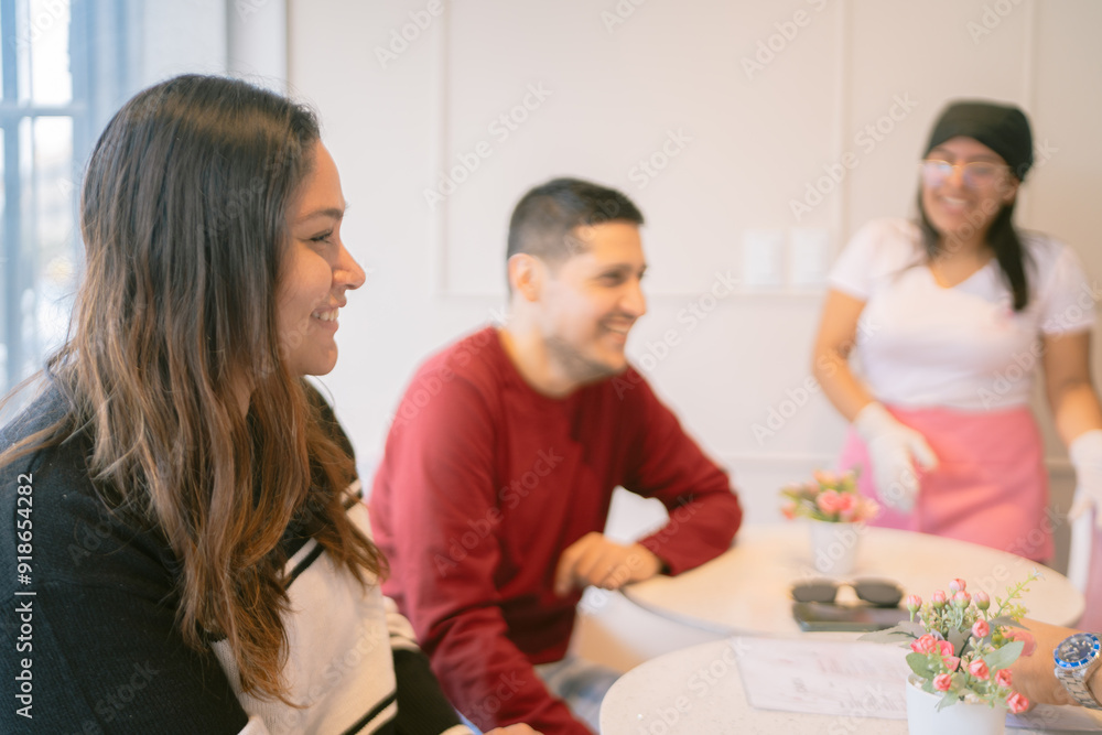 Happy customers ordering to a smiling waitress in a coffee shop Happy customers ordering to a smiling waitress in a coffee shop