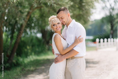 Happy Bride and Groom Embracing Outdoors on Their Wedding Day