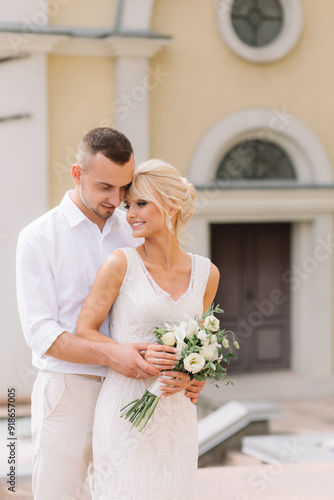 Happy Bride And Groom Posing Together On Their Wedding Day Outdoors