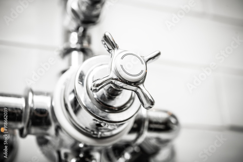 Close-Up of a Modern Chrome Faucet Handle with Smooth Finish in Bright Bathroom Setting for Home Renovation Projects