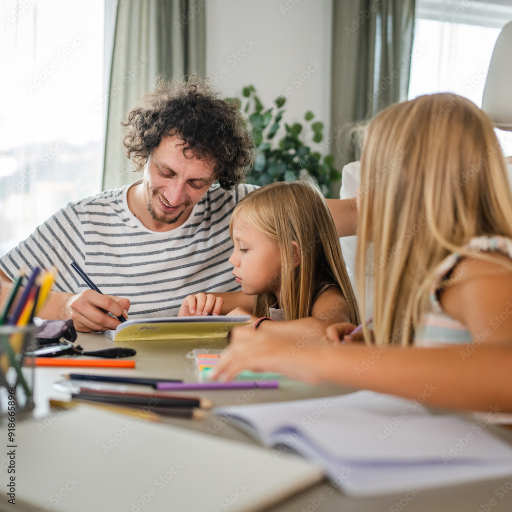 Single father write homework and study with his daughters Single father write homework and study with his daughters