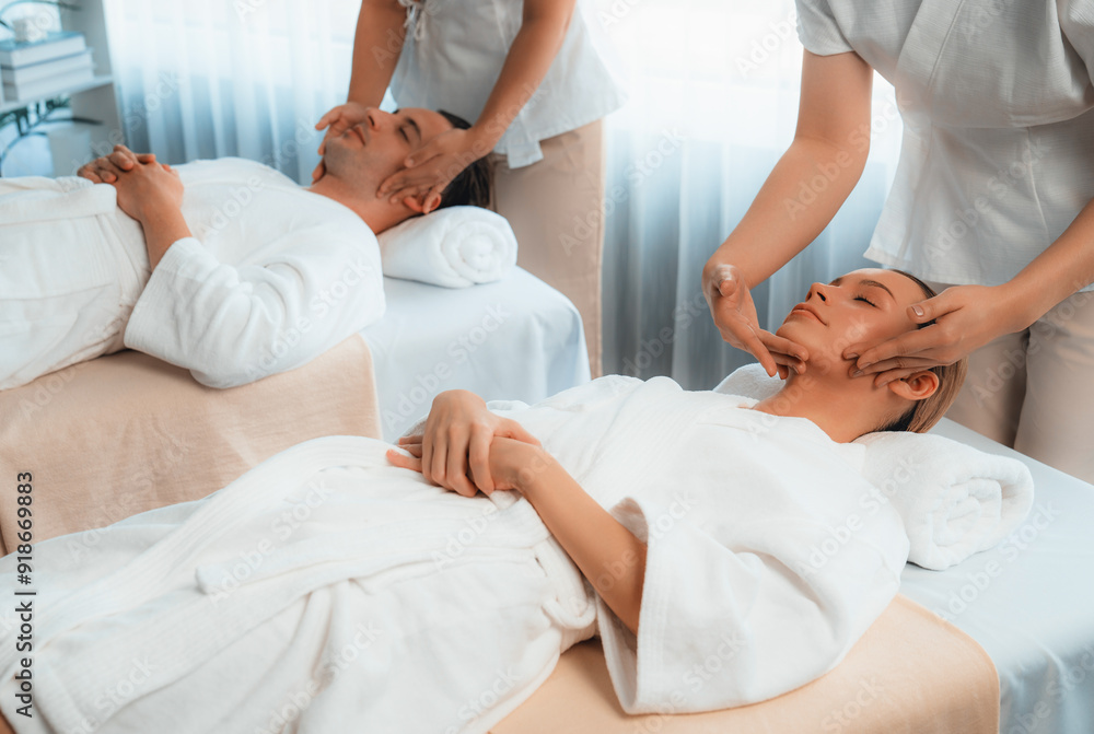 Obraz premium Caucasian couple enjoying relaxing anti-stress head massage and pampering facial beauty skin recreation leisure in dayspa modern light ambient at luxury resort or hotel spa salon. Quiescent