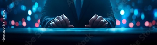 A stylish close-up of hands on a table with a vibrant, illuminated background, perfect for corporate or tech visuals.