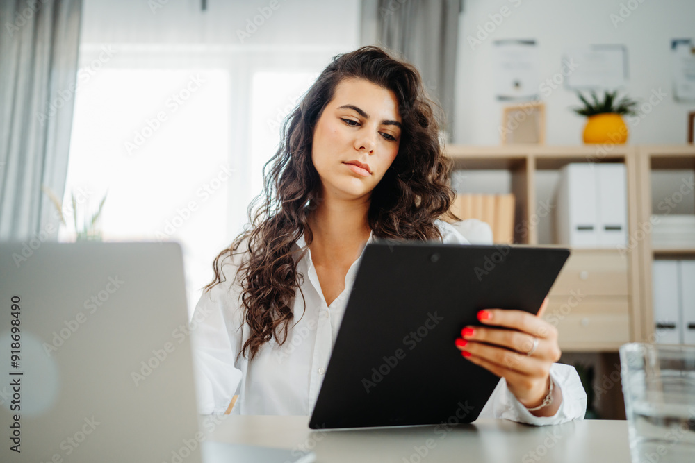 Young caucasian business woman working in office on laptop Young caucasian business woman working in office on laptop