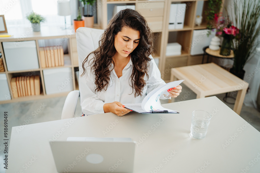 Young caucasian business woman working in office on laptop Young caucasian business woman working in office on laptop