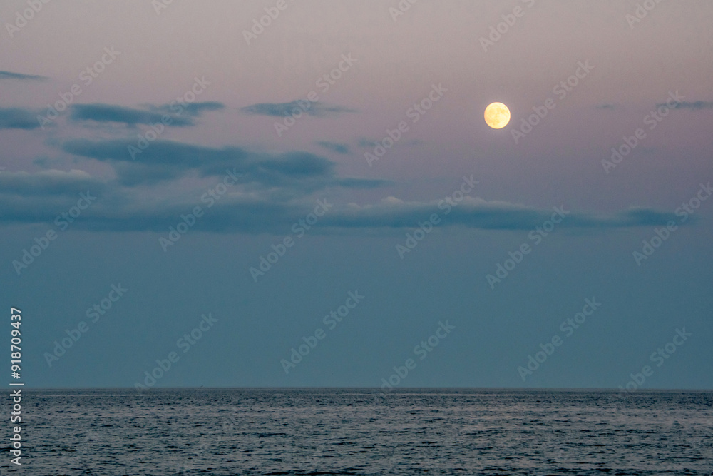 Full moon rises over the Atlantic ocean Full moon rises over the Atlantic ocean