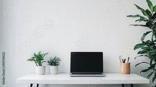 a laptop computer sitting on top of a white desk