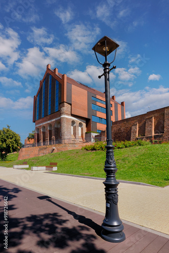 Malbork, Poland - a promenade along the Nogat River near the Teutonic Castle, on the right the rebuilt municipal public library in the former Latin school	 photo