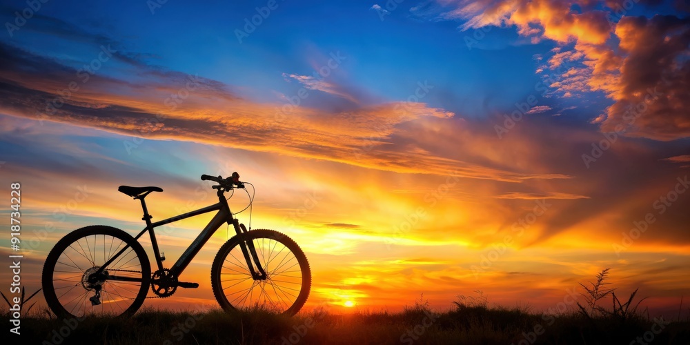 Fototapeta premium Silhouette of a bicycle or ebike against a vibrant sunset background, silhouette, bicycle, ebike, sunset, colorful, sky