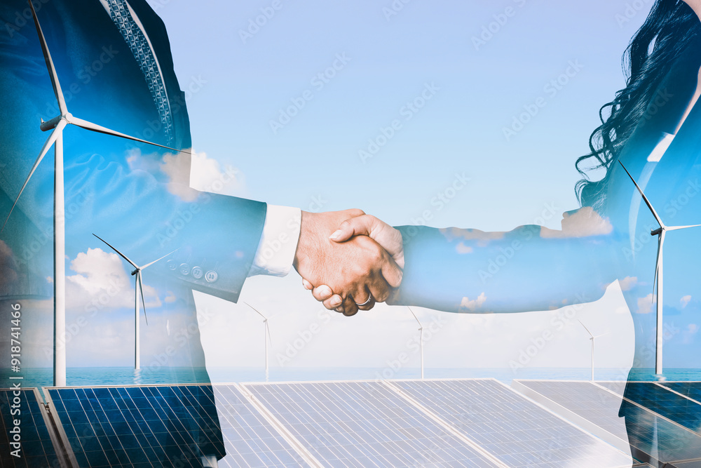 © InfiniteFlow - Double exposure graphic of business people handshake over wind turbine farm and green renewable energy worker interface. Concept of sustainability development by alternative energy. uds