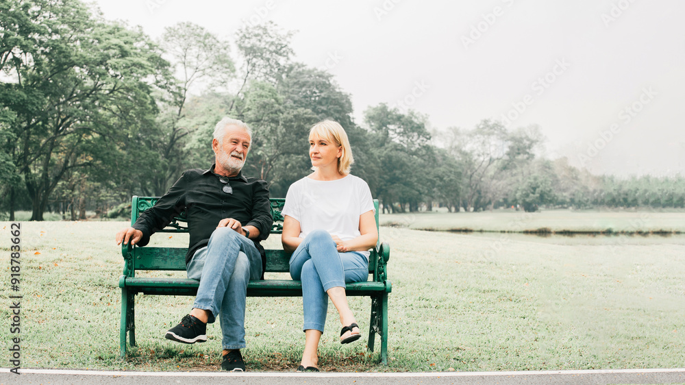 Lifestyle Senior Couple happy senior couple sitting on bench in the park with legs crossed in park nature. Old age and relationships concept Lifestyle Senior Couple happy senior couple sitting on bench in the park with legs crossed in park nature. Old age and relationships concept