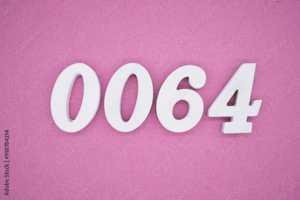 The numbers are made of white painted wood. Laying on the floor was pink paper. The numbers are made of white painted wood. Laying on the floor was pink paper.