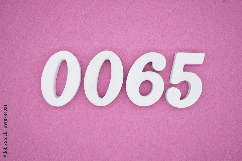 The numbers are made of white painted wood. Laying on the floor was pink paper. The numbers are made of white painted wood. Laying on the floor was pink paper.