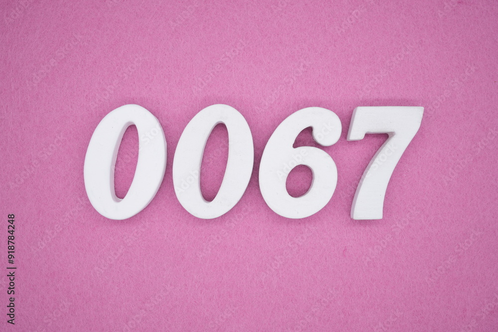 The numbers are made of white painted wood. Laying on the floor was pink paper. The numbers are made of white painted wood. Laying on the floor was pink paper.
