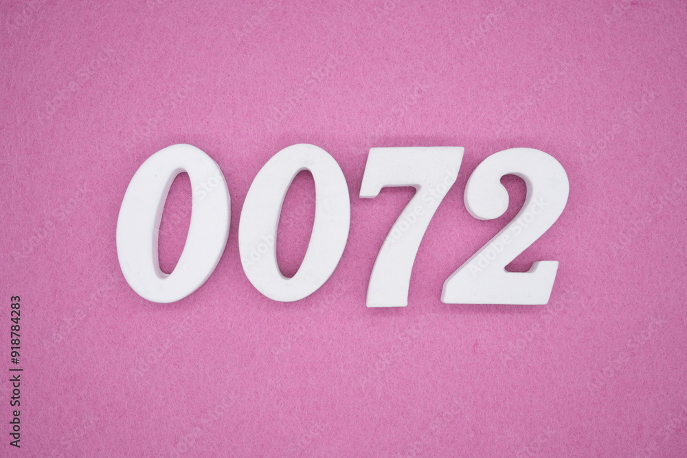 The numbers are made of white painted wood. Laying on the floor was pink paper. The numbers are made of white painted wood. Laying on the floor was pink paper.