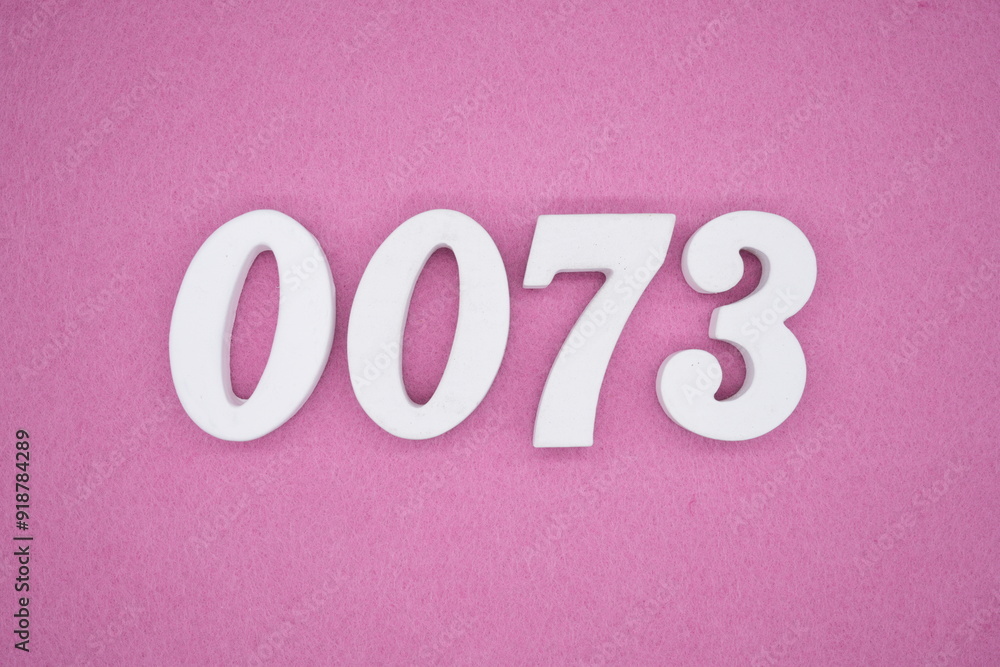 The numbers are made of white painted wood. Laying on the floor was pink paper. The numbers are made of white painted wood. Laying on the floor was pink paper.
