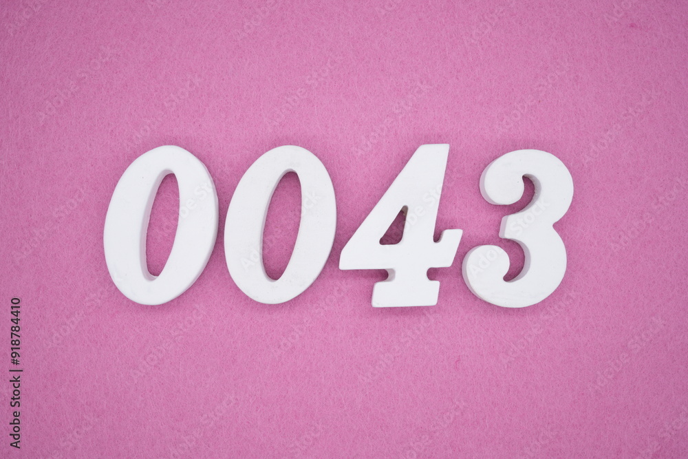 The numbers are made of white painted wood. Laying on the floor was pink paper. The numbers are made of white painted wood. Laying on the floor was pink paper.