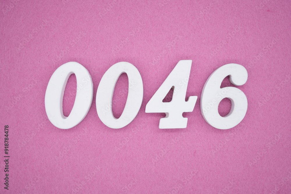 The numbers are made of white painted wood. Laying on the floor was pink paper. The numbers are made of white painted wood. Laying on the floor was pink paper.