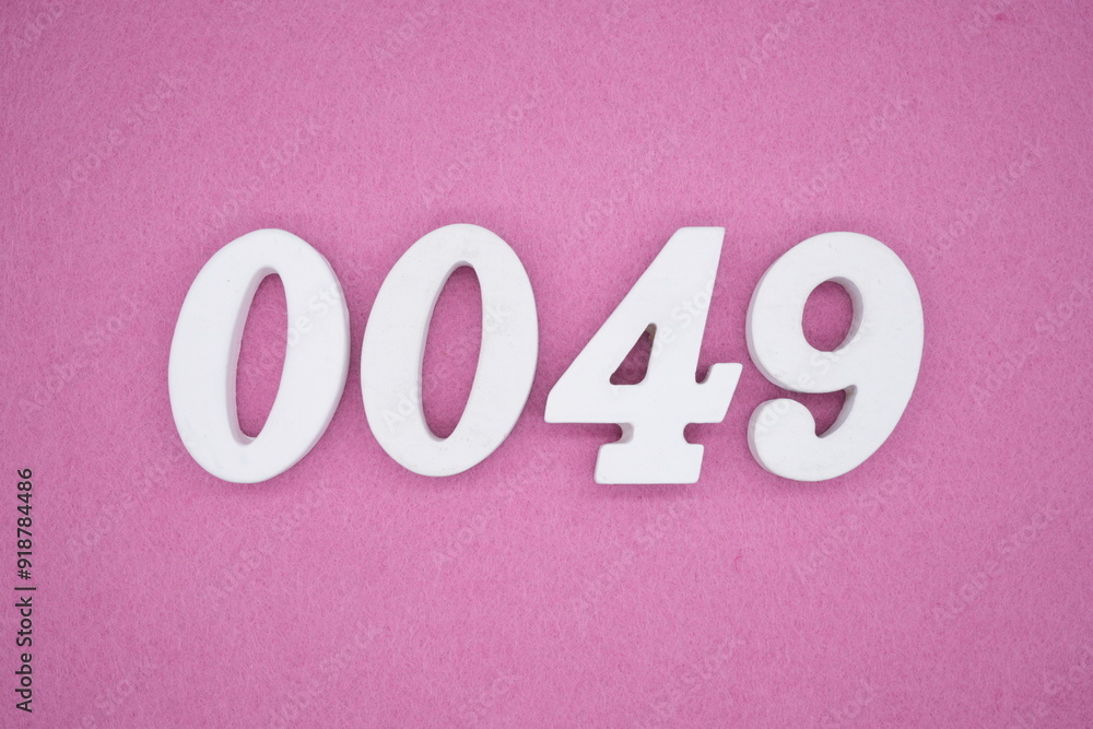 The numbers are made of white painted wood. Laying on the floor was pink paper. The numbers are made of white painted wood. Laying on the floor was pink paper.