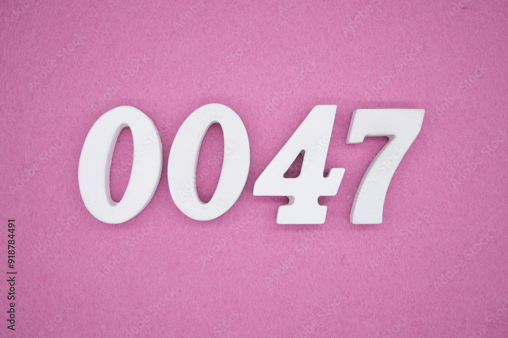The numbers are made of white painted wood. Laying on the floor was pink paper. The numbers are made of white painted wood. Laying on the floor was pink paper.
