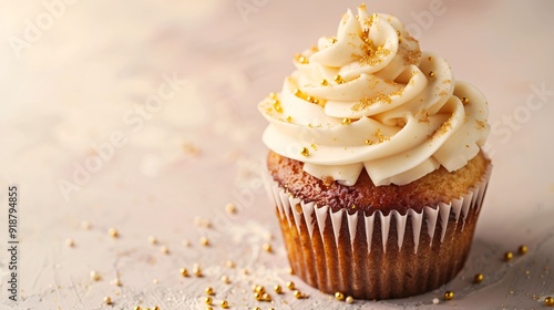 4. A deliciously decorated cupcake featuring cream cheese frosting and golden sugar sprinkles, captured on a light background with ample negative space for banner text