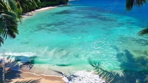 Wallpaper Mural Tranquil beach scene with palm trees swaying in the breeze and turquoise waters lapping the shore. Torontodigital.ca