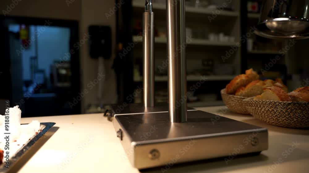 Empty kitchen with warm light over plated food, stainless steel counter. Pan left Empty kitchen with warm light over plated food, stainless steel counter. Pan left