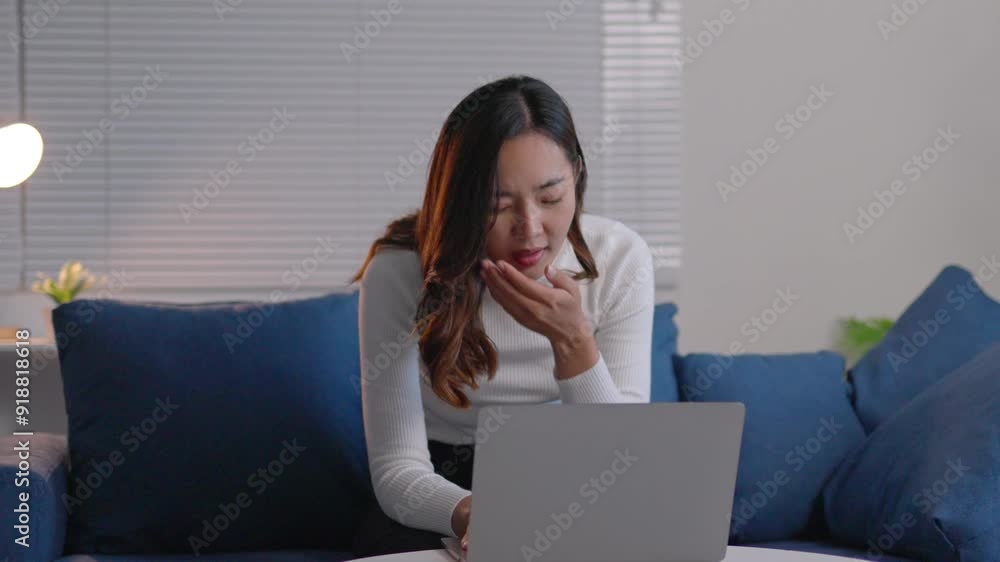Young professional woman working on a laptop, showing signs of fatigue and finally giving in to sleep on a sofa. Captures the reality of overworked professionals Young professional woman working on a laptop, showing signs of fatigue and finally giving in to sleep on a sofa. Captures the reality of overworked professionals