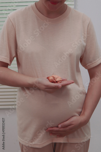 Wallpaper Mural Asian woman, pregnant and radiant, prepares for childbirth against a white background, focusing on her upcoming journey into motherhood with anticipation, calm, and a sense of readiness. Torontodigital.ca