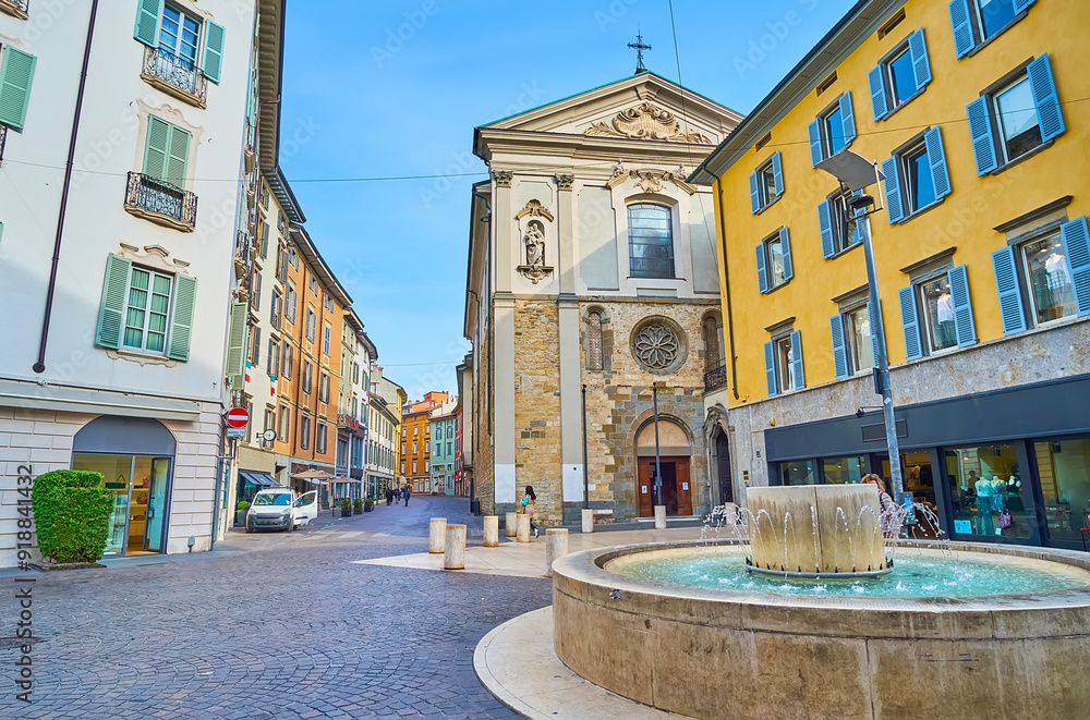 The modern fountain and historic San Leonardo Church, Bergamo, Italy