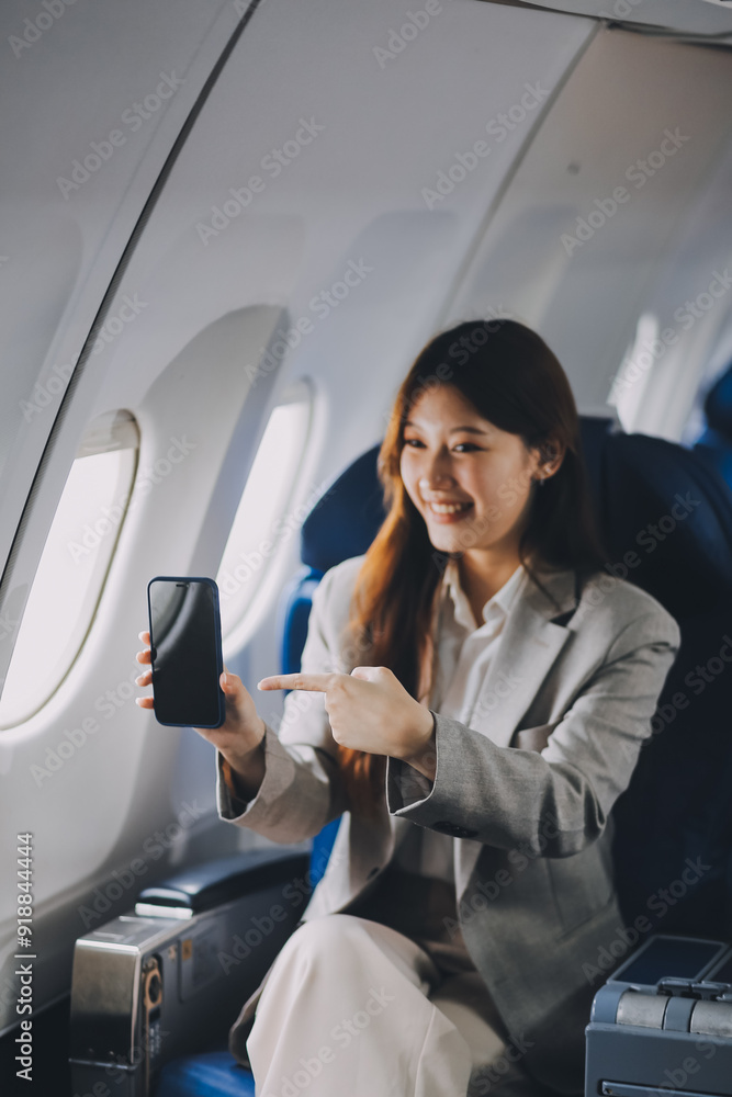 A young Asian woman, seated as an airplane passenger, contemplates dollar bills, reflecting on lucrative opportunities and aspirations towards billionaire status. A young Asian woman, seated as an airplane passenger, contemplates dollar bills, reflecting on lucrative opportunities and aspirations towards billionaire status.