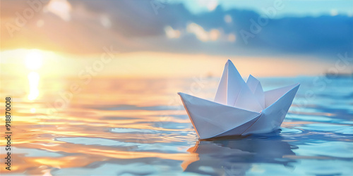 origami paper ship on water with sunset sky background, version 1