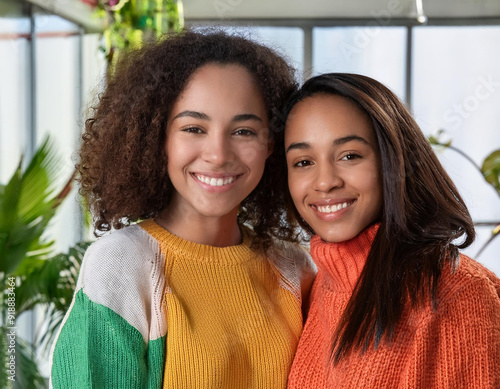 Joyful and Warm Portrait of Diverse, Biracial, Mixed Ethnicity, Loving, and Happy Sisters Sharing a Beautiful Moment Together photo