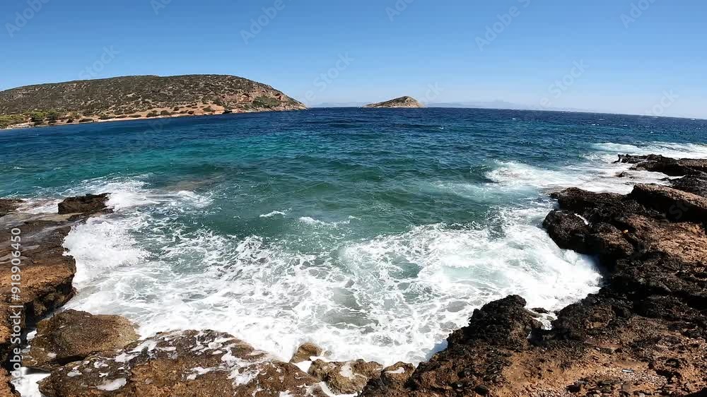 Panoramic view of a bay during summertime. Waves are hitting the rocks of the shore. Very wide angle view. Panoramic view of a bay during summertime. Waves are hitting the rocks of the shore. Very wide angle view.