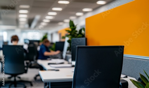 Wallpaper Mural blurred modern office workspace with workers at computers, orange partitions, and plants Torontodigital.ca