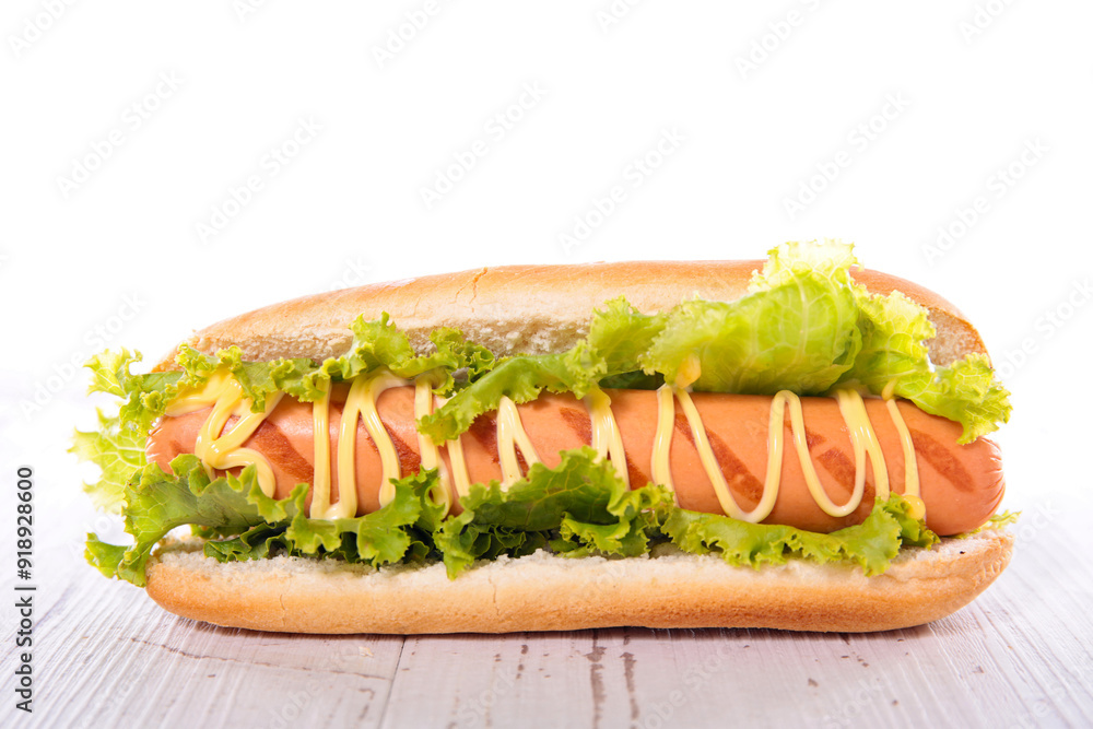 hot dog with sausage, lettuce and sauce hot dog with sausage, lettuce and sauce