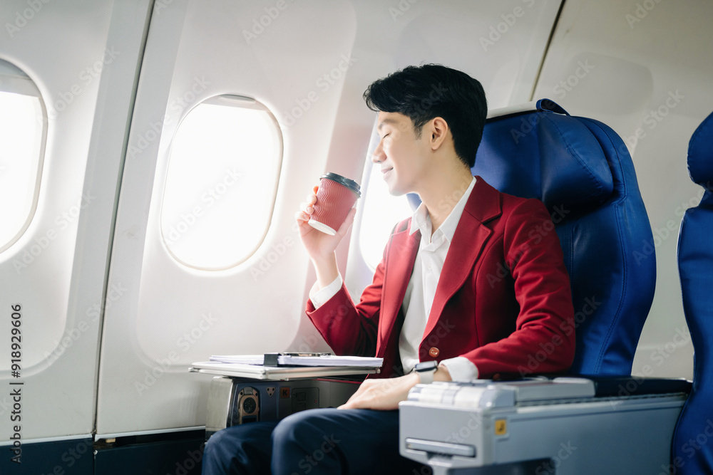 Young Asian executive excels in first class, multitasking with digital tablet, laptop and smartphone. Young Asian executive excels in first class, multitasking with digital tablet, laptop and smartphone.