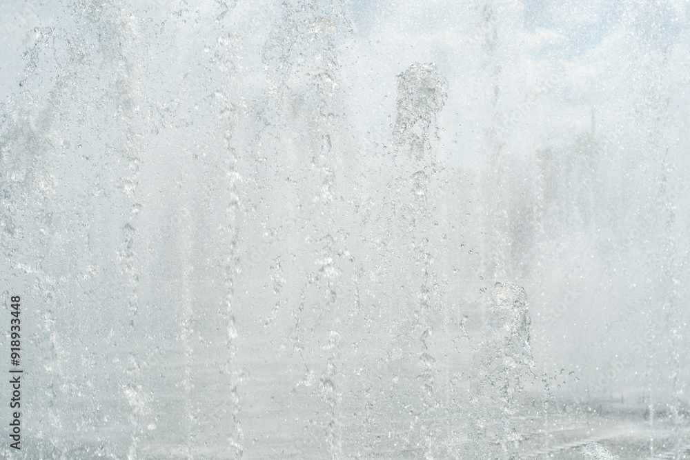 Light background with water from fountains. Jets of water completely blocking the view. Light background with water from fountains. Jets of water completely blocking the view.