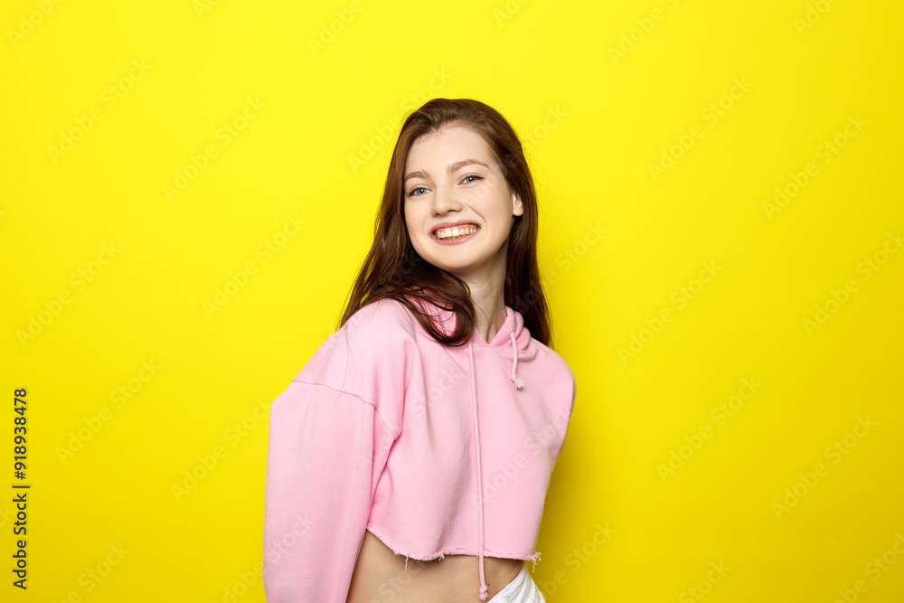 Young Female Model Posing In Pink Clothes On Bright Yellow Background Young Female Model Posing In Pink Clothes On Bright Yellow Background