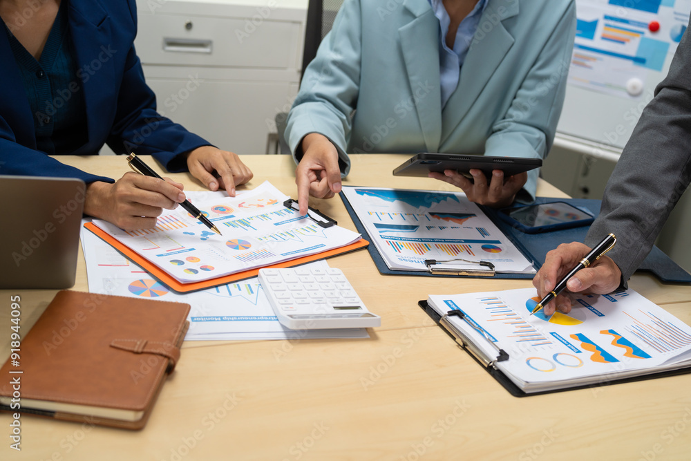 A businessperson financial analyst during a corporate meeting. review a graph document, discussing financial data and strategies to ensure successful outcomes effective teamwork achieving corporate A businessperson financial analyst during a corporate meeting. review a graph document, discussing financial data and strategies to ensure successful outcomes effective teamwork achieving corporate