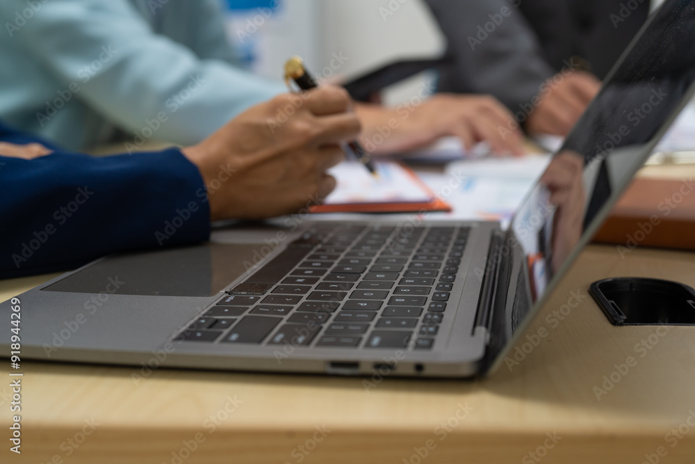 A businessperson financial analyst during a corporate meeting. review a graph document, discussing financial data and strategies to ensure successful outcomes effective teamwork achieving corporate A businessperson financial analyst during a corporate meeting. review a graph document, discussing financial data and strategies to ensure successful outcomes effective teamwork achieving corporate
